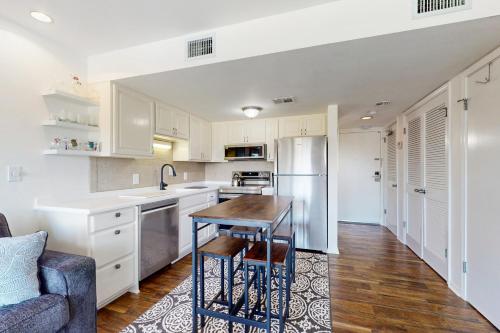 a kitchen with white cabinets and a table in it at Plantation West 1267 in Gulf Highlands