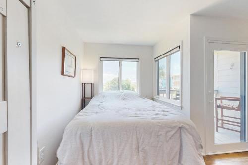 a white bedroom with a bed and a window at Plantation West 1267 in Gulf Highlands