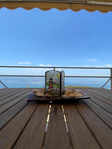 a tray of food sitting on a table on a deck at Scenic View Apartment by Saronida Beach in Saronida