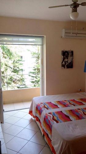 a bedroom with a bed and a large window at Scenic View Apartment by Saronida Beach in Saronida
