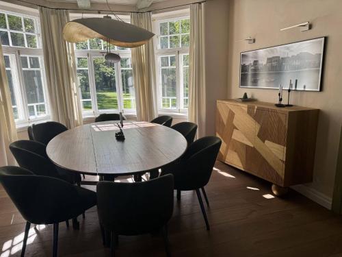 a dining room with a table and chairs at Silma Retreat Hunting Castle in Herjava