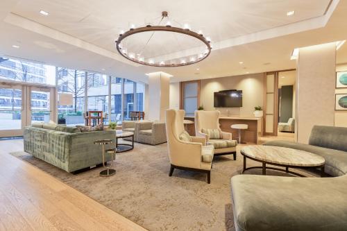 a living room with furniture and a chandelier at Luxury Apt Downtown Seaport in Boston