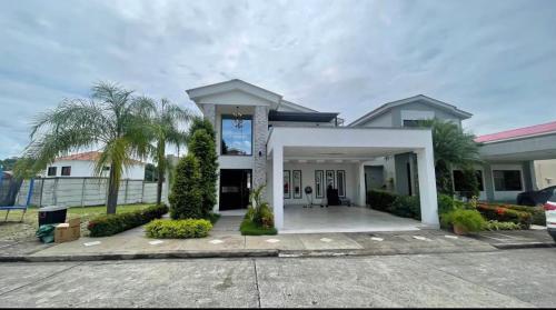 a large white house with a driveway at Lujosa casa samborondon in SamborondÃ³n
