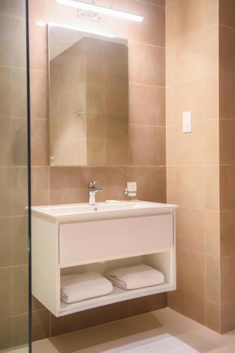 a bathroom with a white sink and a mirror at Segal Rotana Salalah Villa with private swimming pool 2 in Ma‘mūrah