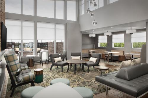 a rendering of a lobby with tables and chairs at Residence Inn by Marriott San Antonio SeaWorld /Westover Hills in San Antonio