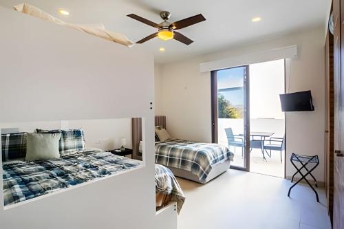 a bedroom with a bed and a ceiling fan at Alamar Vallarta vta in Cruz de Huanacaxtle