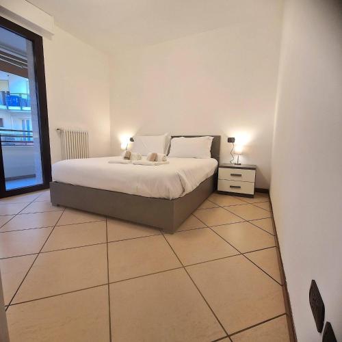 a bedroom with a bed with two lamps on it at Central Apartment Caniggia 1 with Terrace in Como in Como