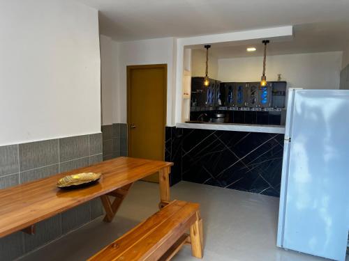 a kitchen with a wooden table and a counter at YelaMar House in Ciudadela Costa de Oro