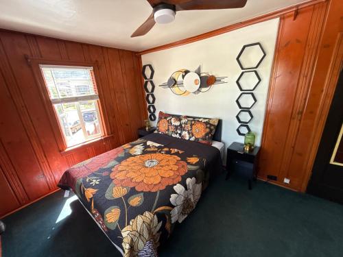 a bedroom with a bed with a floral comforter at Panama Hotel and Suites in San Rafael