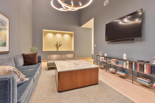 a living room with a couch and a flat screen tv at Luxury Apt In Heart of Seaport in Boston
