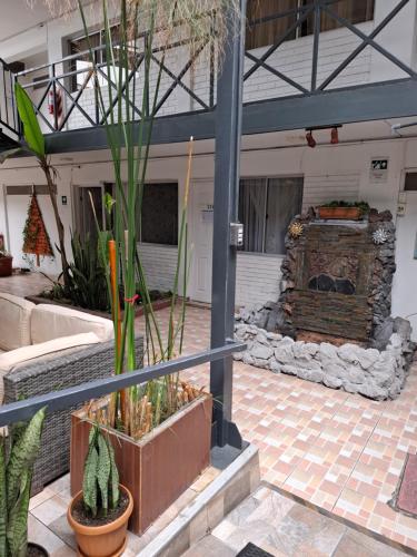 a courtyard with plants and a fireplace in a building at Hotel las Dunas in Iquique