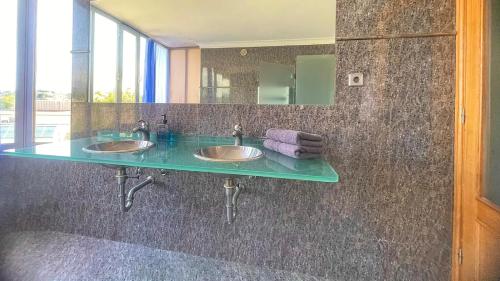 a bathroom with two sinks and a mirror at Douro Villa in Porto
