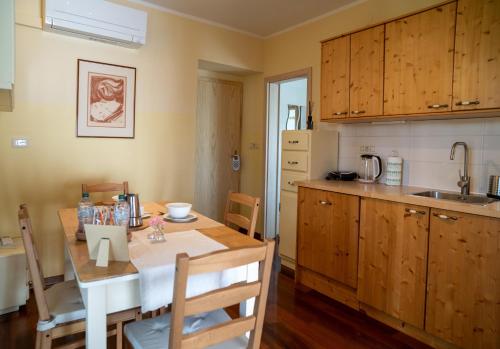 a kitchen with a table and a dining room at Hiša pri poetu in Šempeter pri Gorici