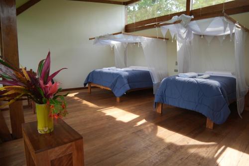 Ένα ή περισσότερα κρεβάτια σε δωμάτιο στο Ecotone Manu Bio Lodge All-Inclusive