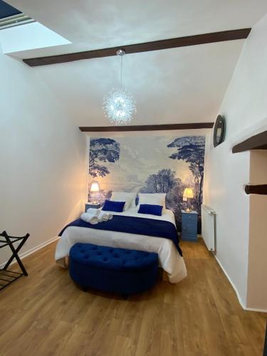 a bedroom with a large bed and a chandelier at Manoir des 2 Sources in Monestier