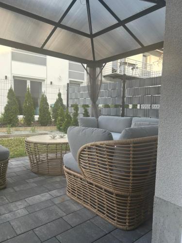 a patio with a couch under an umbrella at Apartament Origami - IDEALNY- ocena gości in Kudowa-Zdrój