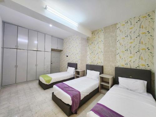 a room with two beds and cabinets in it at Ipoh Tambun pool villa 5br 18pax bbq mahjong in Tambun