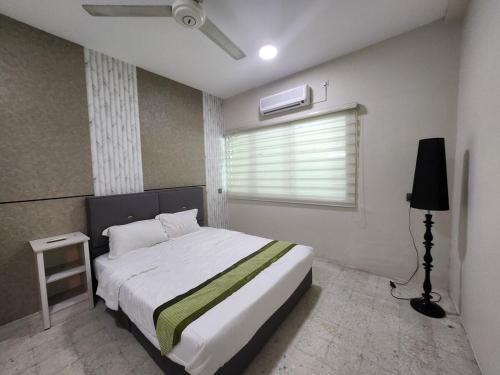 a bedroom with a large bed and a window at Ipoh Tambun pool villa 5br 18pax bbq mahjong in Tambun