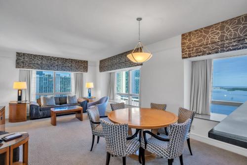 a living room with a table and chairs and a couch at Four Seasons Miami Two Bedroom - 2Bath Ocean view Suite - Amazing views in Miami