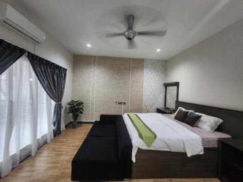 a bedroom with a bed and a ceiling fan at Ipoh Tambun pool villa 5br 18pax bbq mahjong in Tambun