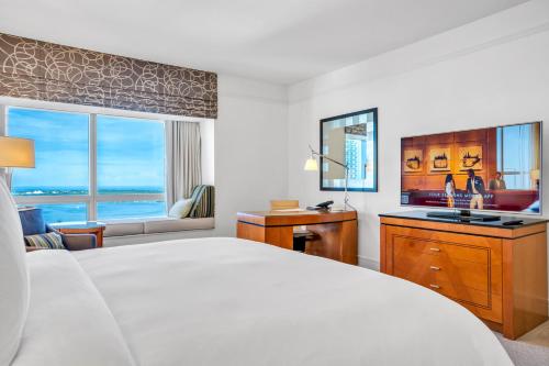 a bedroom with a bed and a desk and a sink at Four Seasons Miami Two Bedroom - 2Bath Ocean view Suite - Amazing views in Miami