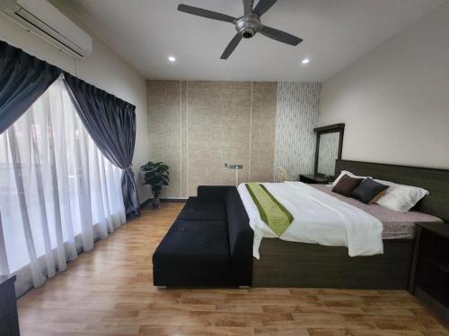 a bedroom with a bed and a ceiling fan at Ipoh Tambun pool villa 5br 18pax bbq mahjong in Tambun