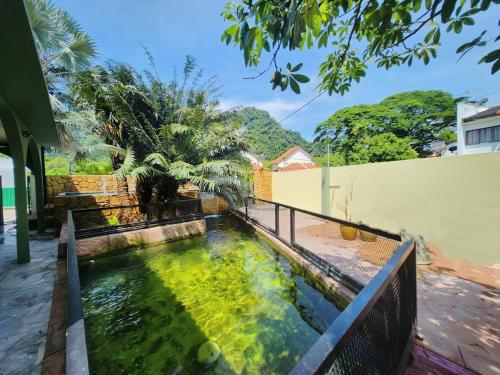 a koi pond in front of a house at Ipoh Tambun pool villa 5br 18pax bbq mahjong in Tambun