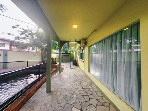 a house with a balcony with a swimming pool at Ipoh Tambun pool villa 5br 18pax bbq mahjong in Tambun
