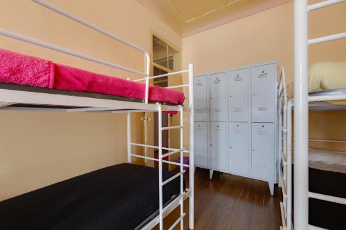a room with two bunk beds and a closet at Suntrap Hostel in Lagos