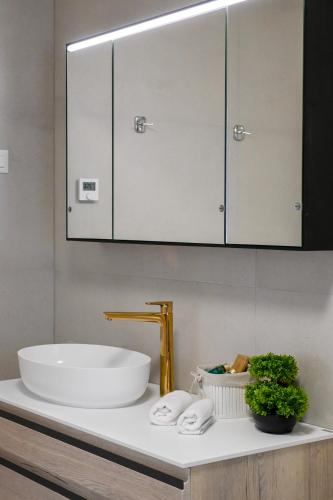 a bathroom with a sink and a mirror at B&B Zora Panoramic View in Milna