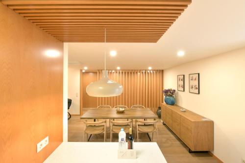 a dining room with a table and chairs at BUTEKO HOUSE AL in Miranda do Douro