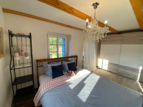 a bedroom with a bed and a chandelier at The Secret Garden in Cheb
