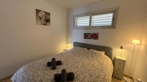 A bed or beds in a room at Apartments Paradise Lloret