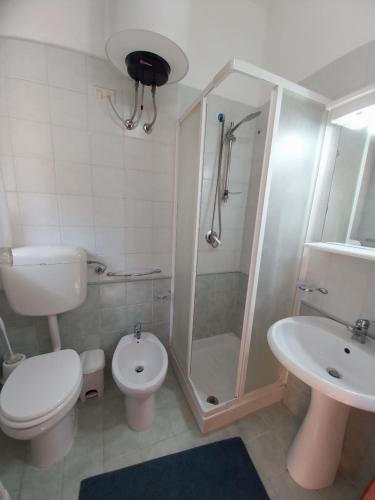 a bathroom with a shower and a toilet and a sink at Caterina in Isola delle Femmine