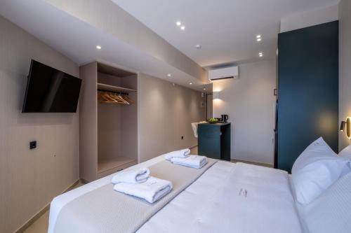 a bedroom with a bed with towels on it at Agora Views in Athens