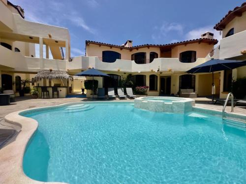 a swimming pool in front of a building at Puerto Nuevo Surf Villa Margarita 2BR with pool in Raulis