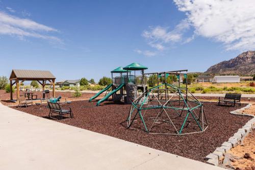 a playground with a slide and benches in a park at Cozy modern tiny home near ZION & private deck in Apple Valley