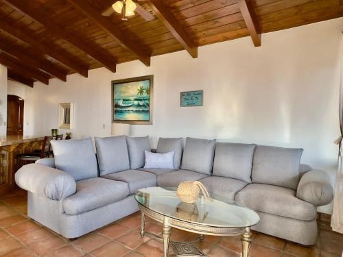 a living room with a couch and a table at Puerto Nuevo Surf Villa del Mar 2BR with pool in Raulis