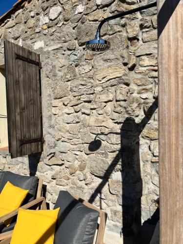 a stone building with a street light on it at Remparts House in Mailhac
