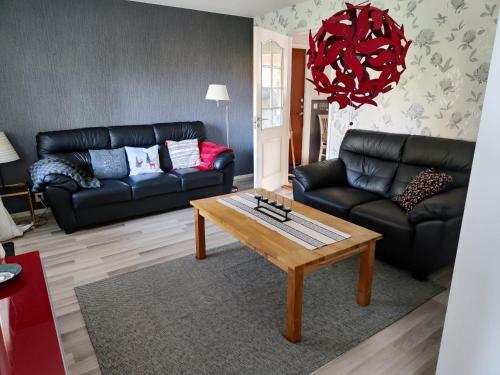 a living room with a couch and a coffee table at Pauliström - Schöne Ferienwohnung für bis zu 4 Personen - 60qm in Pauliström