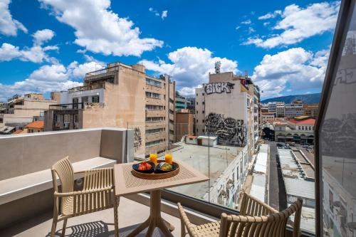 a table on a balcony with a view of a city at Agora Views in Athens