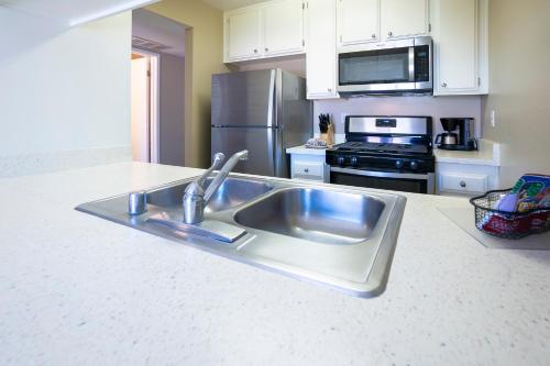 a kitchen with a stainless steel sink and appliances at Indian Palms Vacation Club in Indio