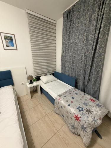 a small bedroom with a bed and a window at Adam & Eve Family Apartment in Dobra Voda