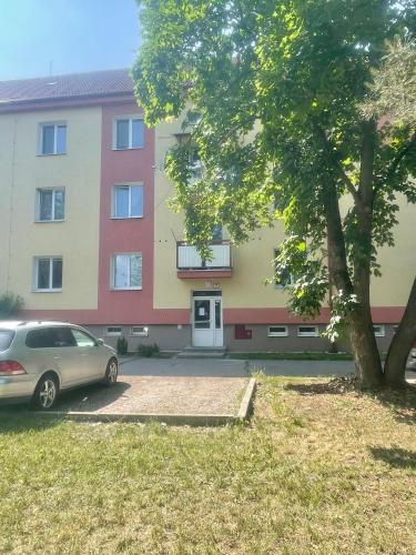 a car parked in a parking lot in front of a building at Apartman Cañas Zelená Víla in Rimavská Sobota