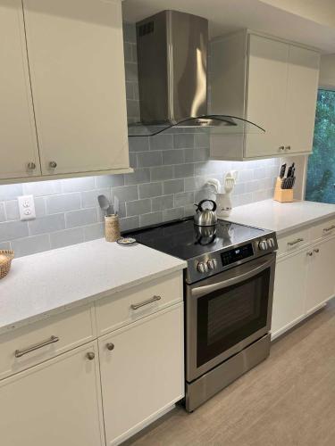a kitchen with white cabinets and a stove top oven at 1515 Deer Pointe Villa in Seabrook Island