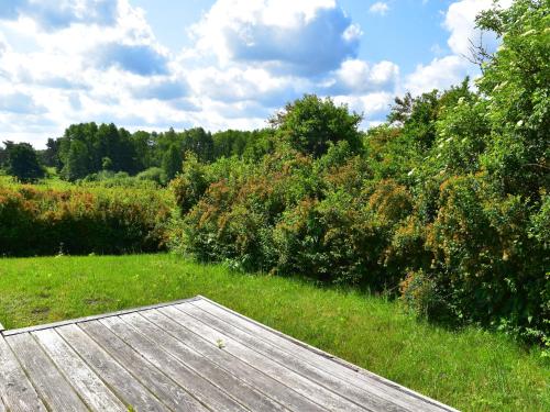 a wooden deck in the middle of a field at Ferienhaus am Garder See Inselblick in Lohmen