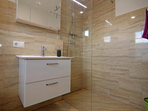 a bathroom with a sink and a shower at Reihenhaus am Gardersee in Garden