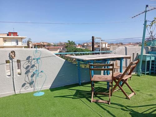 a table and a chair sitting on a roof at Kiato Rooftop Garden Apartment in Kiáton