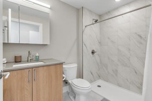 a bathroom with a shower and a toilet and a sink at Lux 2BD with KINGS - Pier Views - Near Fishtown! in Philadelphia