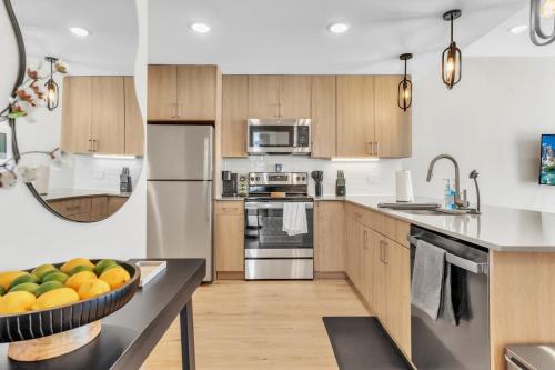 a kitchen with a bowl of fruit on a counter at Lux 2BD with KINGS - Pier Views - Near Fishtown! in Philadelphia